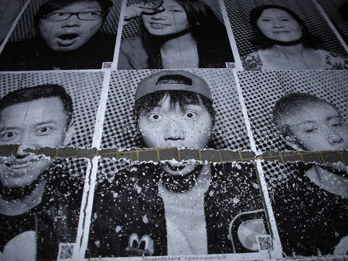 Starting in 2011, JR and his team photographed individuals as part of a global project called "Inside Out." These portraits were pasted on walls in a central part Shanghai in 2014.