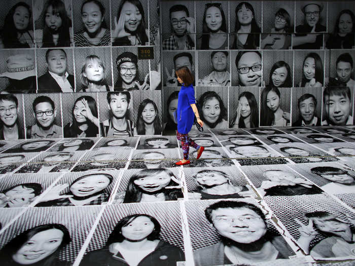 A woman walks through a display of JR