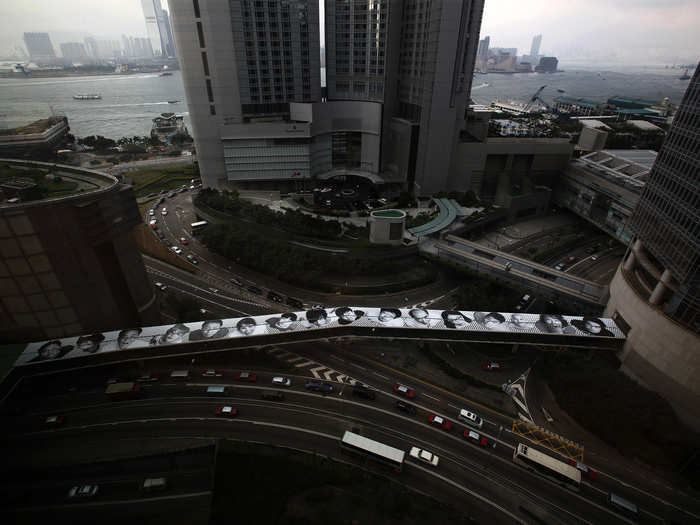 A different part of "Inside Out" is displayed on the roof of a foot bridge at Hong Kong