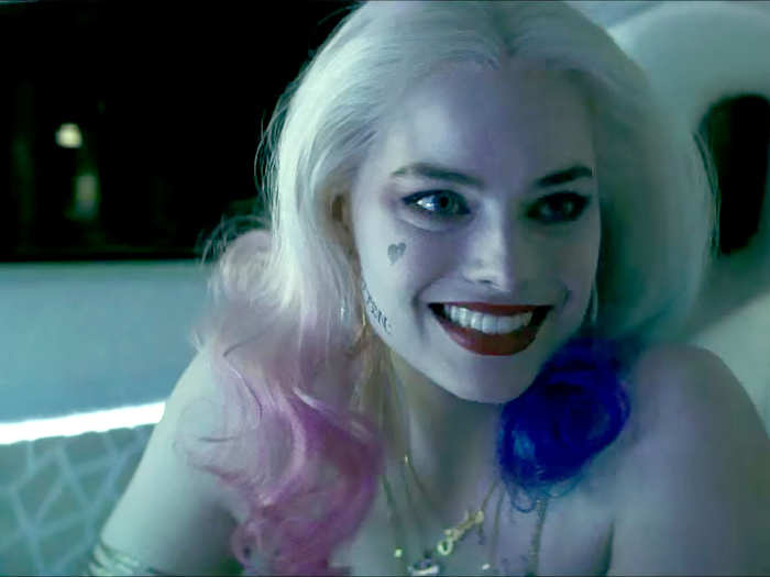 Robbie appears as the cheery and psychotic Harley Quinn, Joker