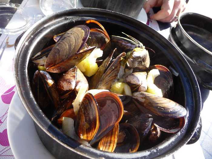 While moules frites (mussels and french fries) is considered a Belgian dish, Moules Marinières is a French dish from Normandy and translates to sailor-style mussels. It