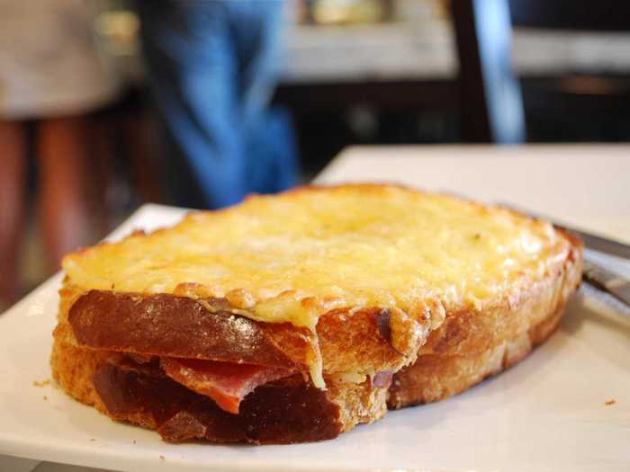 The French version of a grilled cheese sandwich, the croque-monsieur features jambon (ham) and melted gruyère cheese on the inside, with rich béchamel sauce oozing out all over the sandwich.