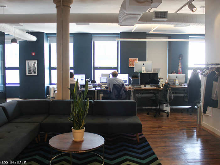 The actual work gets done upstairs, where desks are arranged by team.