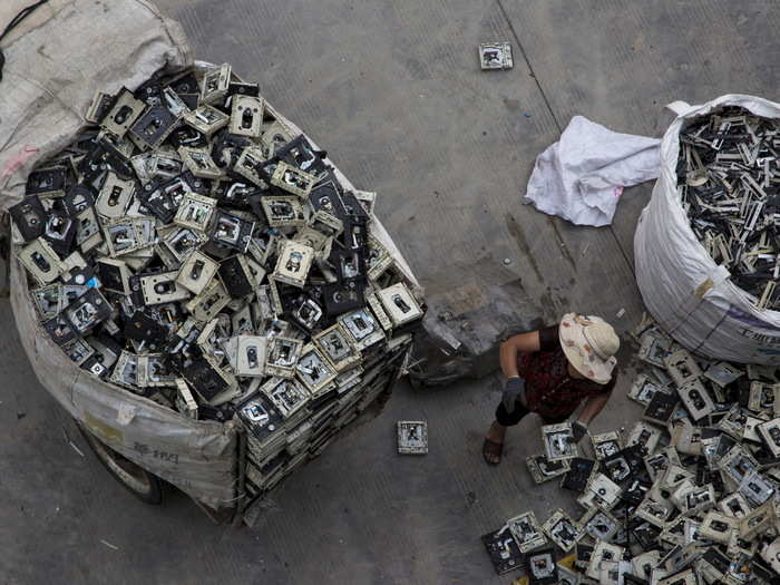 There are around 5,000 government-managed recycling centers in the city. Below is a top-down view of a worker distributing electronic waste.