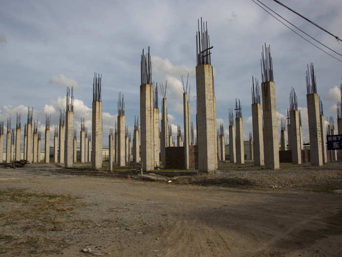 Despite health and environmental concerns, the e-waste recycling business in Guiyu continues to boom. Here, tall spires indicate the construction of a new factory to be used for recycling in a government-managed area.