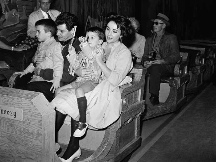 Elizabeth Taylor and boyfriend Eddie Fisher rode one of the fantasy rides during a family outing in 1959.