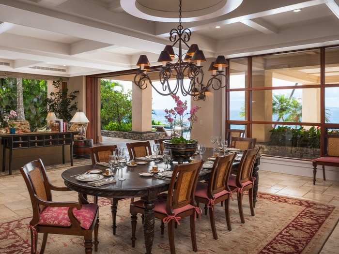 The spacious dining room also features pocket sliding doors and leafy green surroundings.