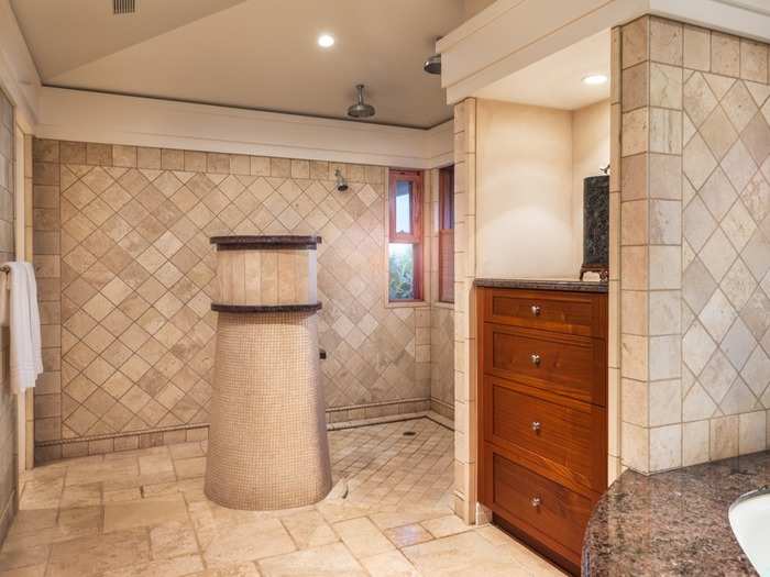 Which is outfitted with an open shower area.