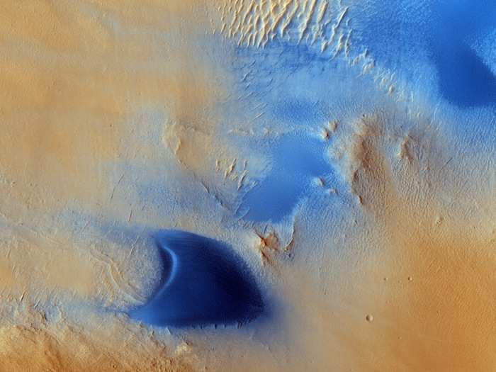 Marth crater is located in a larger region called Arabia Terra, which is one of the dustiest places on Mars and covers an expanse of about 2,800 miles. Here, you can see how winds have blown streaks of dust to the left, or west, of dunes.