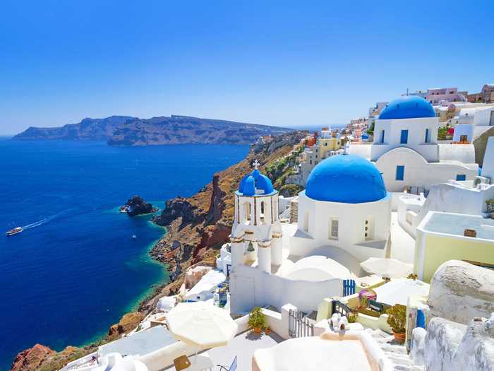 Go island hopping in Greece and marvel at the bright white buildings with rich blue rooftops that line the sea. Santorini, Crete, and Mykonos are some of Greece