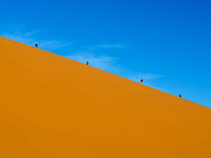 Explore the golden sand dunes of the Namib Desert and the majestic peaks of the Naukluft mountain range at Namib-Naukluft National Park in Namibia.