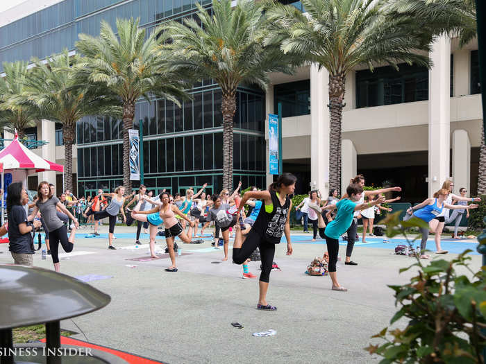 In the morning, girls stretched on the pavement outside the convention center during a free pilates session.