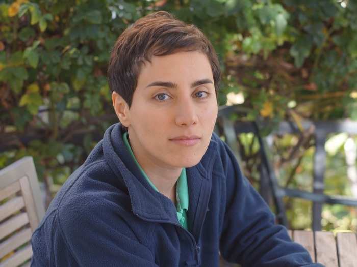 Maryam Mirzakhani is explaining the complicated mathematical relationships that govern twisting and stretching surfaces.
