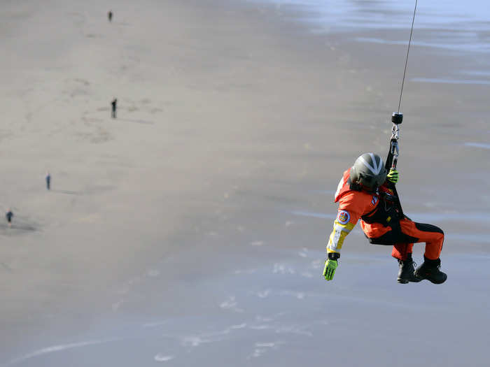 Rescue training can get pretty intense. Here, a Coast Guard aviation survival technician  is lowered from a helicopter during a cliffside rescue exercise in Washington state.