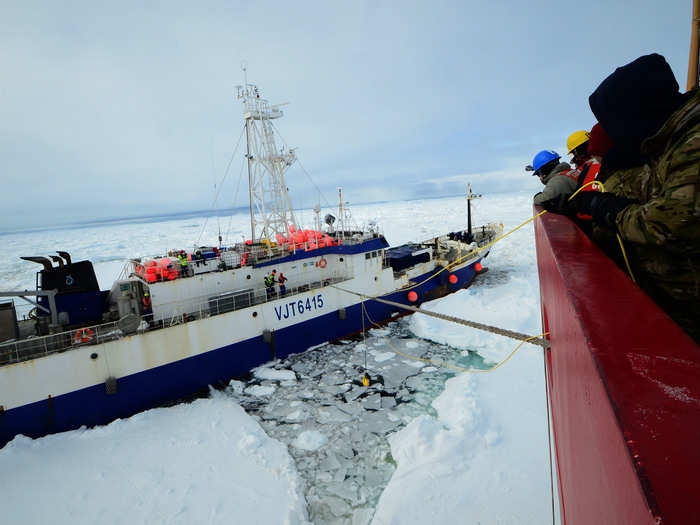 Here, Coast Guard crew members aboard the Polar Star help to free an Australian fishing vessel trapped in Antarctic ice.