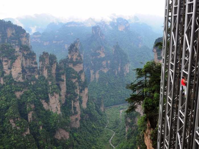 TALLEST OUTDOOR ELEVATOR: Visitors can admire the stunning formations of China’s Zhangjiajie National Forest Park by ascending the 1,070 foot-high Bailong Elevator.