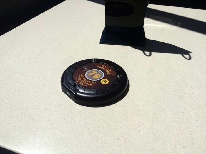 Once your burger is ordered, you grab a table locator and sit down. It tells the servers — that