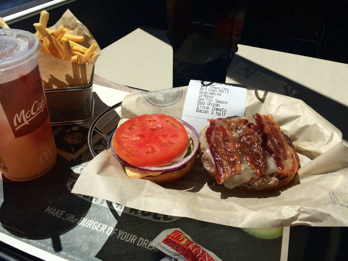 Finally, my meal arrives - and it sure looks worth the wait. I ordered mine with bacon, tomato, fresh onions, natural cheddar cheese, guacamole, Sriracha mayo, and creamy garlic sauce, all on an artisan roll.