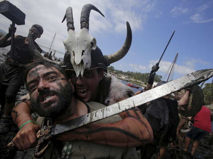 Festival goers relive the battle on the muddy banks of the Ulla river.