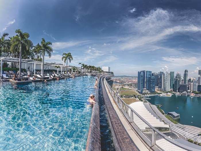 The Marina Bay Sands infinity pool in Singapore is the largest outdoor infinity pool at its height — 57 floors above the city. Swimming in this pool is aptly referred to as "swimming on top of the world."