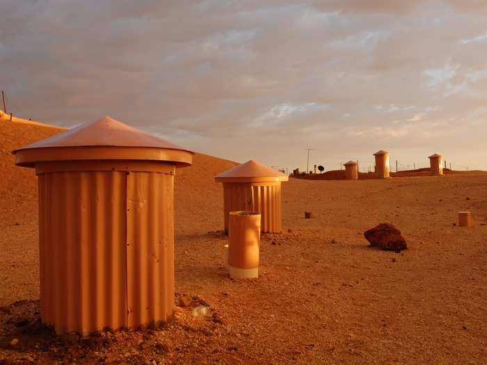 But if you look closer, you can see chimneys poking through the desert terrain.