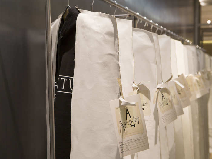 The clothes are covered in white cases that are slit in the middle. No brand logos were seen when a writer from the London-based culture magazine Dazed walked into the revamped store on the opening day.