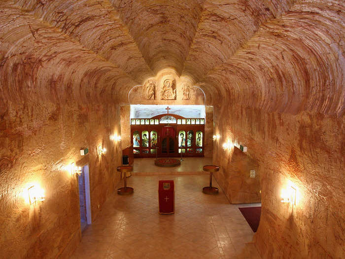 The residents of Coober Pedy in Australia move underground to pray. The Serbian Orthodox Church, built in 1993, is carved in the sandstone and has a community hall, a parish house, and even a school.