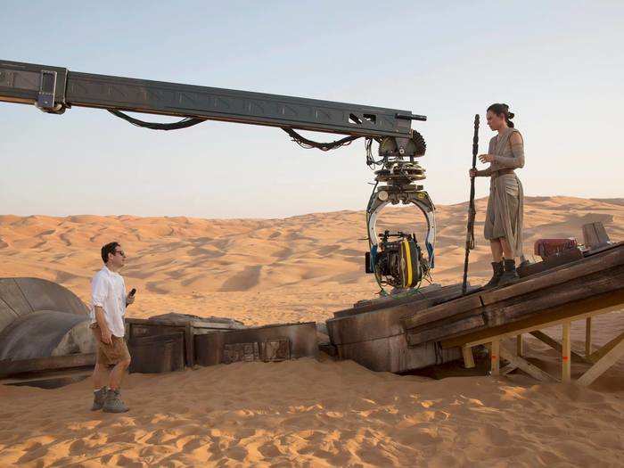 J.J. Abrams gives direction to Daisy Ridley, who plays a character named Rey, on the desert world of Jakku.