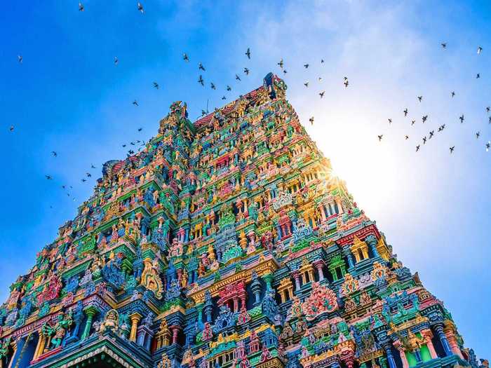 The Meenakshi Temple is located in Tamil Nadu and is a beacon of bright blues, yellows, pinks, and greens. The incredibly detailed layers of the temple reach far into the sky.