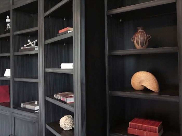 These tall bookcases are not all that they appear to be. They each disguise a secret room: one a storage area, and the other a mini bar. In this shot Findley sent us, you can see how the bookcases open.