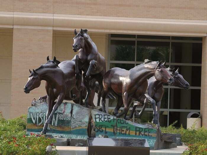 “The Day the Wall Came Down” is a statue in the George H.W. Bush Library, in College Station, Texas. The statue depicts horses bolting for freedom over six broken segments of the Berlin Wall.