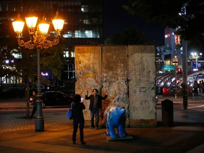 In 2004, the Seoul Metropolitan Government announced the creation of an open plaza area in Seoul, South Korea, that would be known as Berlin Square. With three segments of the Berlin Wall, street lights from Berlin, benches, and German trees, the Plaza has been built to stand as a symbol of hope for the reunification of North and South Korea.