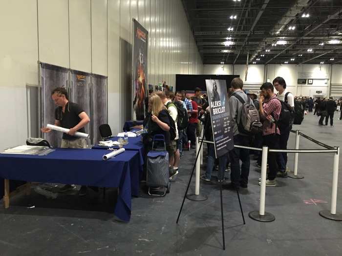 Some fans were waiting to get posters and cards signed by Aleksi Briclot, an artist who paints the images for cards.