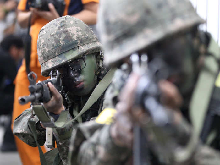 Here, soldiers aim their weapons during an anti-terror drill at the Sadang Subway Station in Seoul.