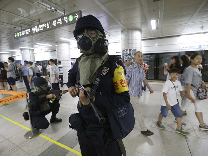 A South Korean policeman stands at the ready in the Sadang Subway Station.