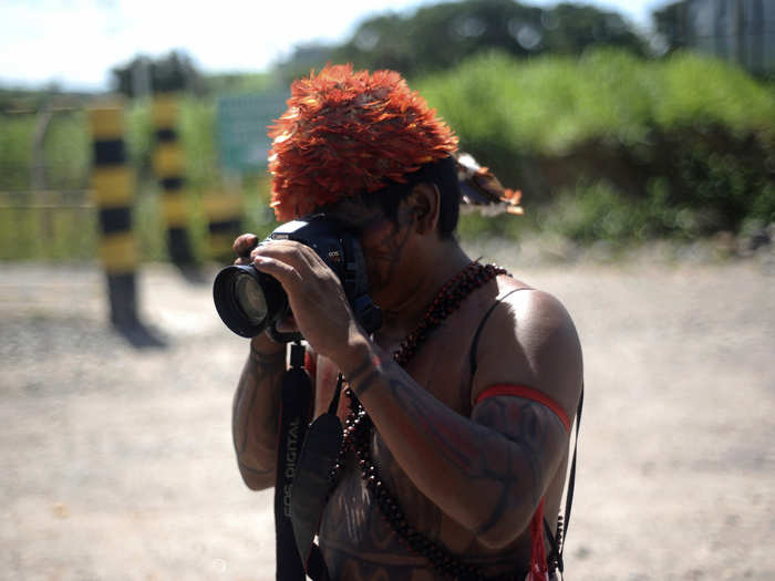 A Munduruku Indian takes photos with a camera left for him to use by a journalist who was expelled from the Belo Monte hydroelectric dam construction site, in Vitoria do Xingu, near Altamira in Para State. Amazon Indians went through the process of demanding that the Brazilian government hold prior consultations with indigenous peoples before building dams that affect their lands and livelihoods, an issue that has sparked years of protests against the Belo Monte dam.