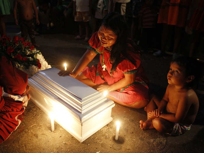 Luz Elaida Queragama, a member of the indigenous Embera Katio tribe, cries beside the coffin of her four-month-old daughter, who died in Cali, Columbia. Queragama discovered that her baby was not breathing one morning. Members of the displaced Katio community came to Cali in 2013 following an armed conflict that was raging in Pueblo Rico, Risaralda. They now live in poverty in Cali, in three houses that are inhabited by 43 families.