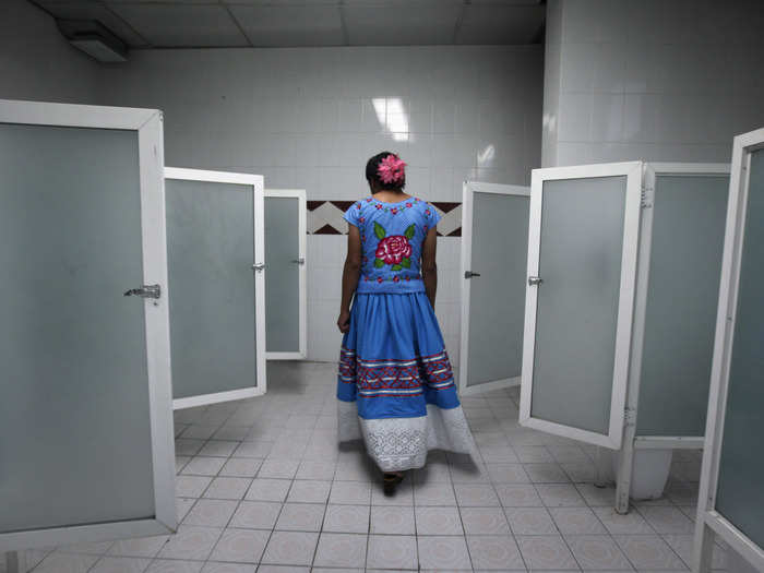 A man dressed as a traditional Zapotec, also known as "Muxe," walks inside a women