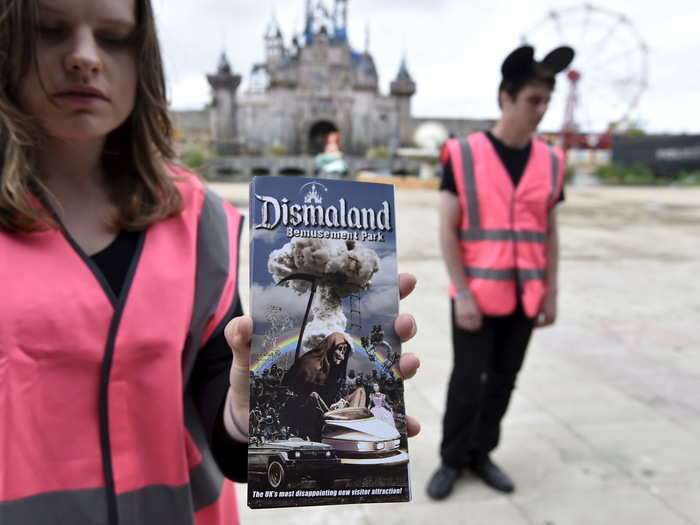 Apathetic attendants wear safety vests and mouse ear hats while telling guests to "end joy" the attractions. Here