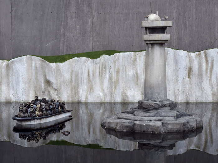 This work portraying a boat of refugees, plus one floating in the water, is a comment on Europe