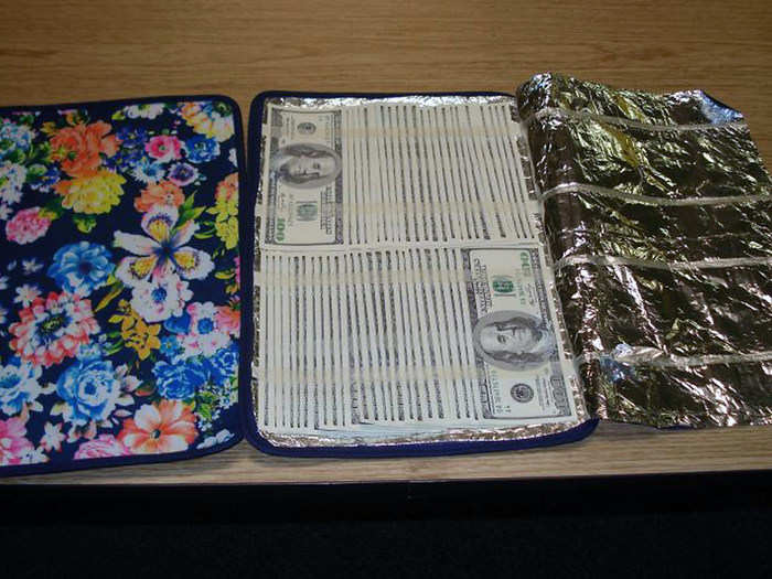 US Customs and Border Protection officers at JFK found $65,200 dollars in counterfeit bills concealed in flimsy floral placemats.