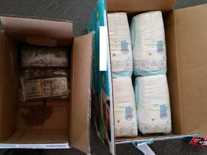 Nearly half a million in unreported cash was hidden in a box of diapers, trash bags, and submerged in a 5-gallon bucket of paint.