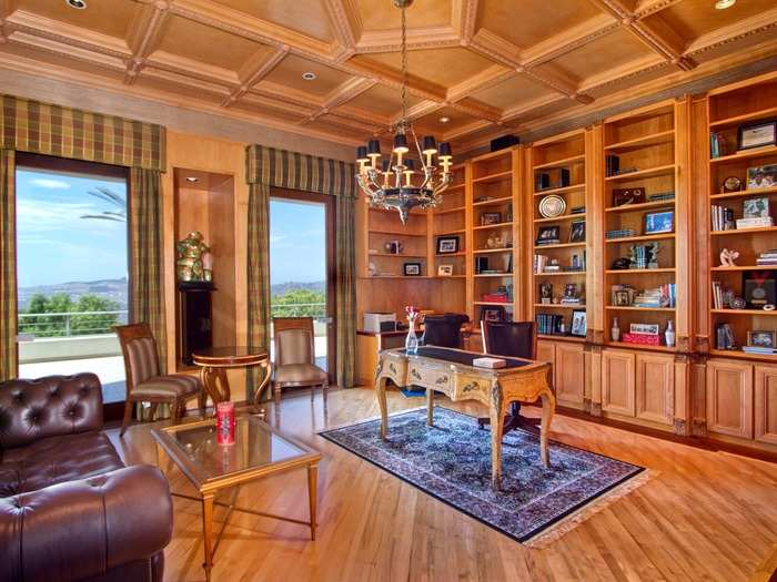 Retreat to the elegant study with built-in shelves and a chandelier that complements the distinguished decor.