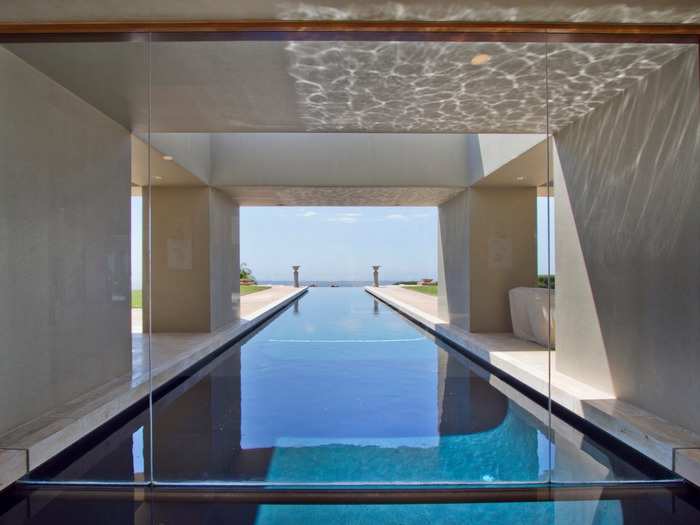 The pool has indoor and outdoor components, and it has an infinity edge with tantalizing views of the Pacific Ocean.