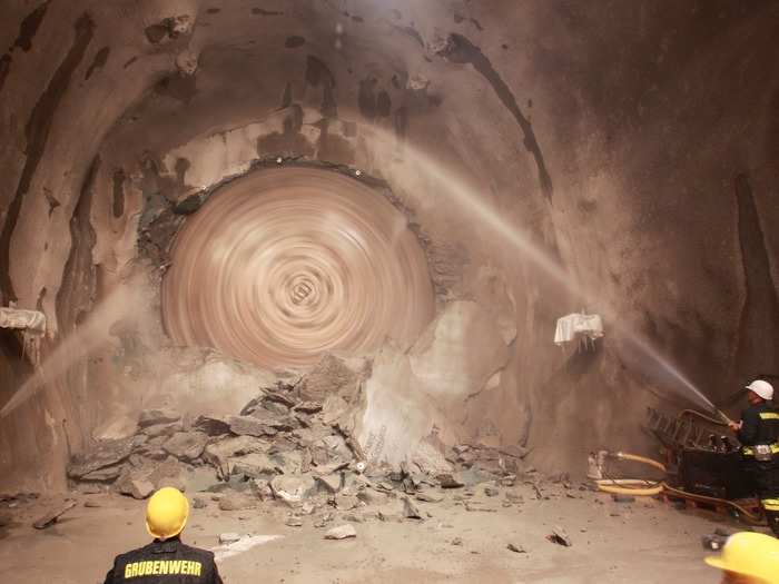 The massive machines must be cooled with water so they don’t overheat while cutting through layers of super-hard gneiss and granite rock.