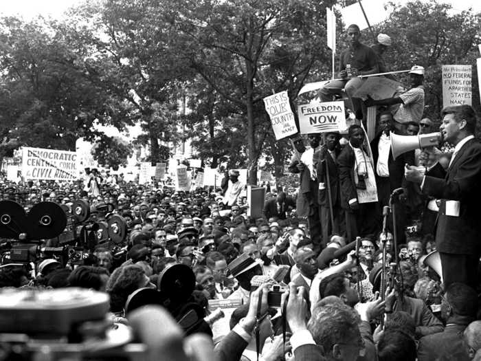 Days later, black demonstrators descended on Washington. Demonstrators marched from the White House to the Department of Justice with few incidents, defying speculations of violence and other negative press. Here, Attorney General Robert Kennedy addresses the crowd with a bullhorn.