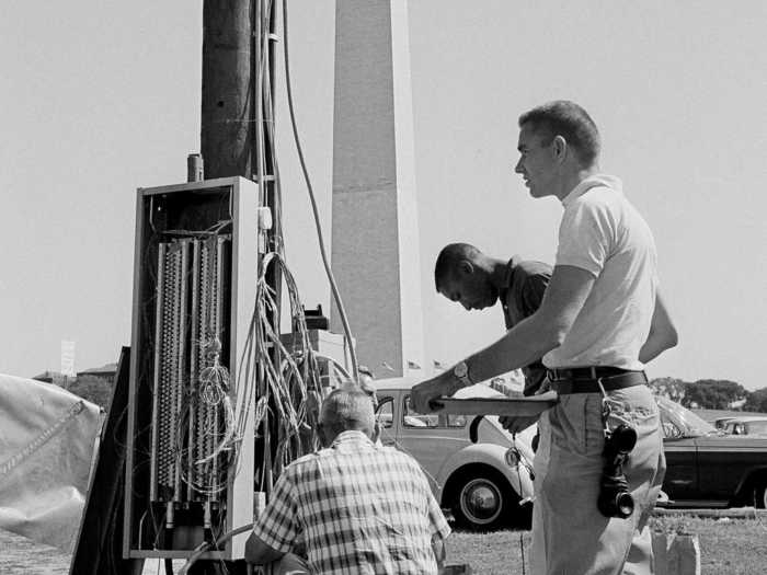 More than 100,000 people were expected to attend the march. Here, workmen install extra telephone poles to uphold general communication at the event.