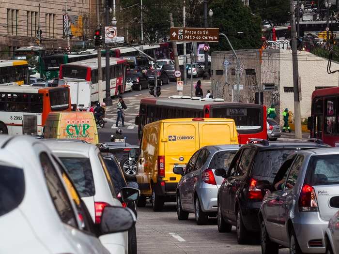 Traffic lanes and parking take precedent over green spaces and outdoor seating. People traveling on foot are quarantined to tiny sidewalks.