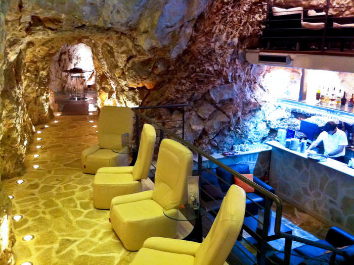 The Cave Bar at Hotel More in Dubrovnik, Croatia, sits inside an awe-inspiring natural cavern with multi-colored lighting that makes the natural environment seem like a fantastical escape. Outside, you can enjoy your drink with views of the Adriatic sea.