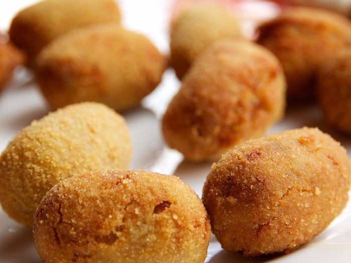 Croquetas are fried balls of deliciousness that are served across bars and restaurants in Spain. They can come with a variety of meat, fish, and vegetable fillings with some of the most popular including ham and cod.